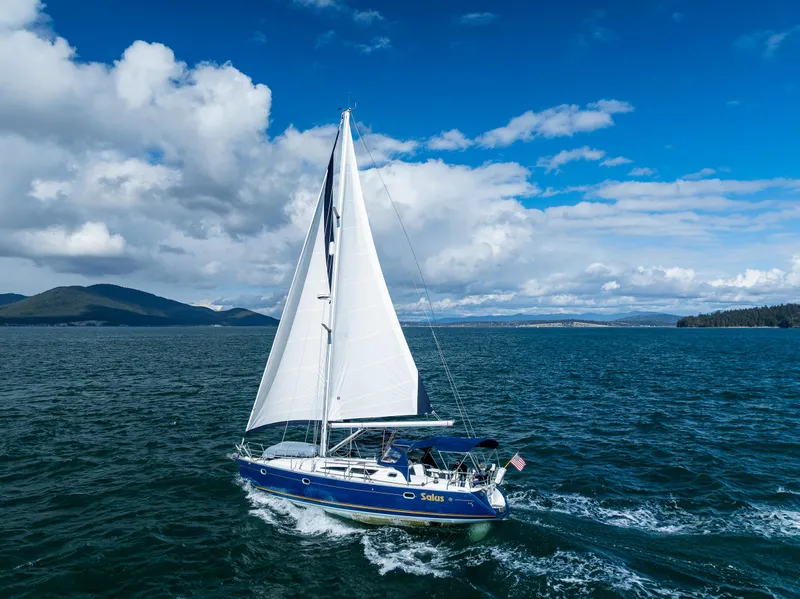 Slide: The Image of Sailing yacht Jeanneau Sun Odyssey 40, 2001 model, cruising on open water under a blue sky. - 7