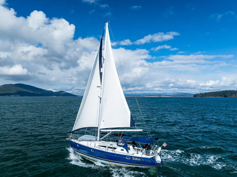 Slide: The Image of Sailing yacht Jeanneau Sun Odyssey 40, 2001 model, cruising on open water under blue skies. - 8