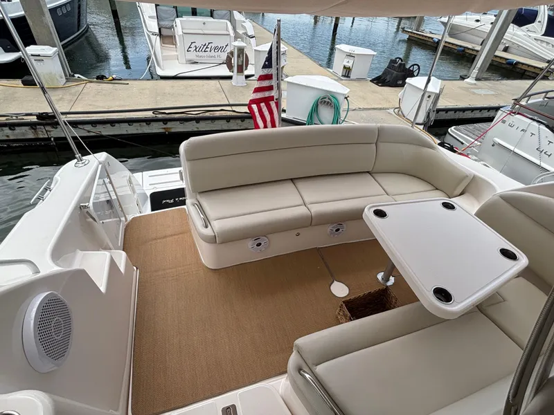 Slide: The Image of 2008 Tiara Yachts 3900 Sovran with beige seating and table at a marina dock. - 10