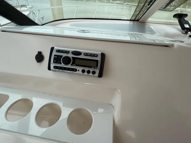 Slide: The Image of 2008 Tiara Yachts 3900 Sovran dashboard with stereo system and cup holders. - 16