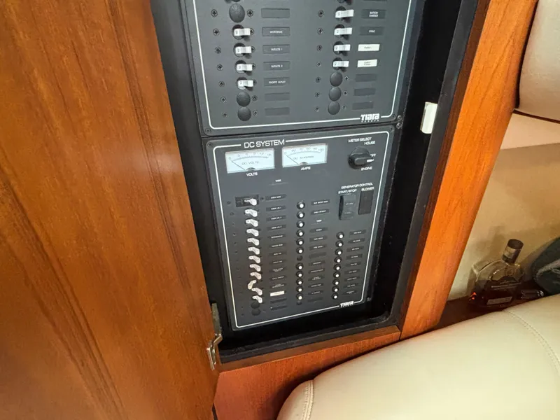 Slide: The Image of 2008 Tiara Yachts 3900 Sovran DC system panel with wooden cabinet. - 19