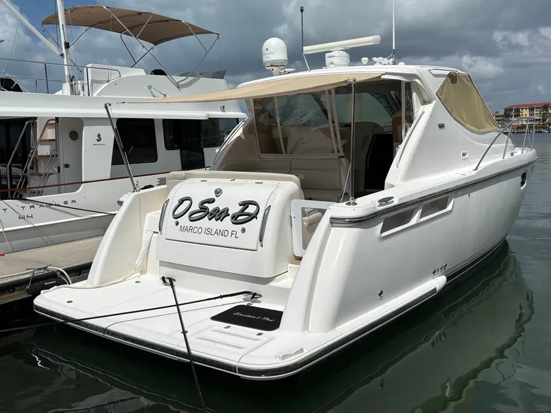 Slide: The Image of 2008 Tiara Yachts 3900 Sovran docked, featuring sleek design and spacious deck. - 2