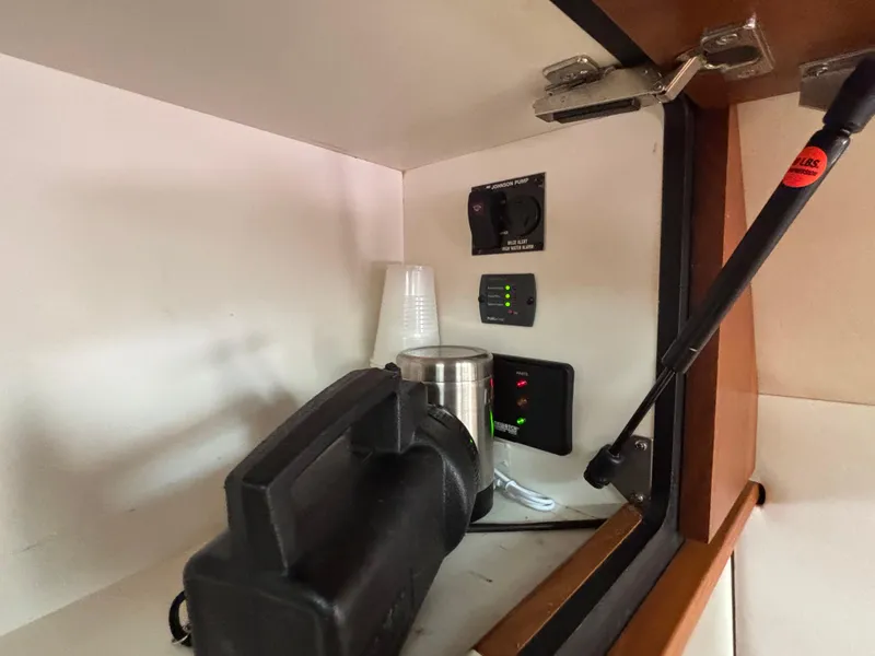 Slide: The Image of 2008 Tiara Yachts 3900 Sovran interior cabinet with equipment and controls. - 21