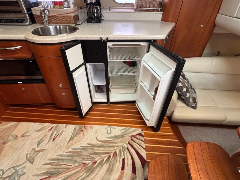 Slide: The Image of Interior of 2008 Tiara Yachts 3900 Sovran with open fridge and modern amenities. - 27
