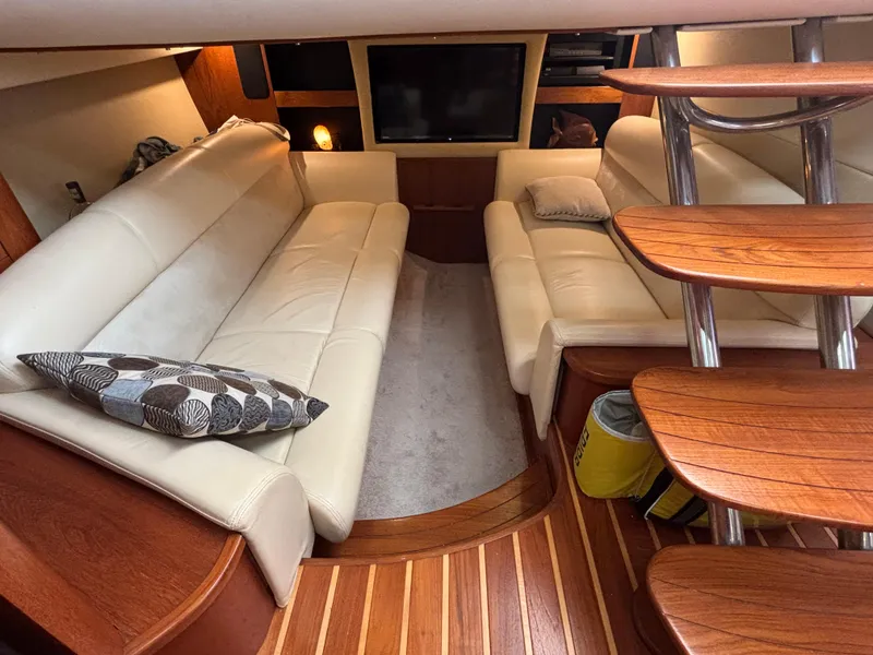 Slide: The Image of 2008 Tiara Yachts 3900 Sovran interior with plush seating and wooden accents. - 29