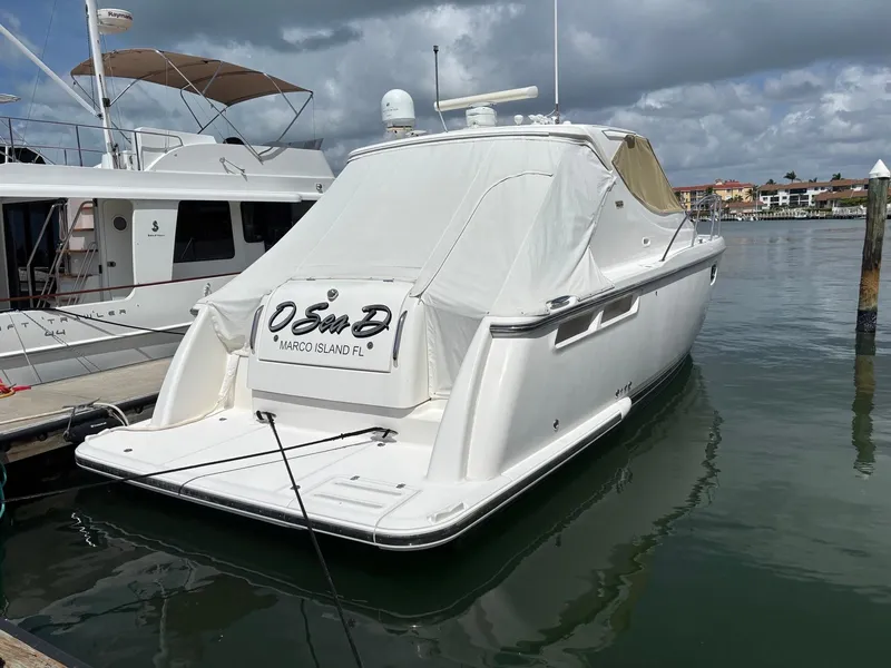Slide: The Image of 2008 Tiara Yachts 3900 Sovran docked at marina under cloudy skies. - 3
