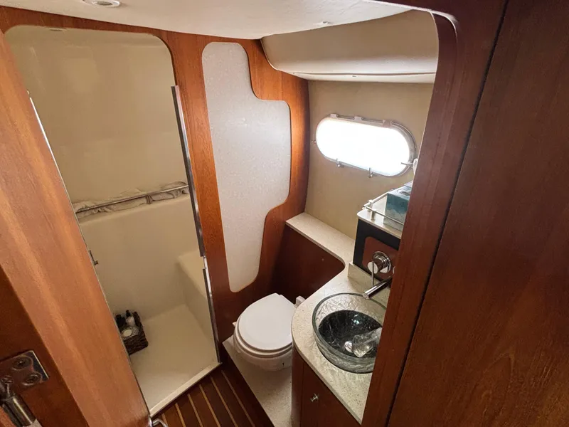 Slide: The Image of 2008 Tiara Yachts 3900 Sovran bathroom with wood accents and modern fixtures. - 31