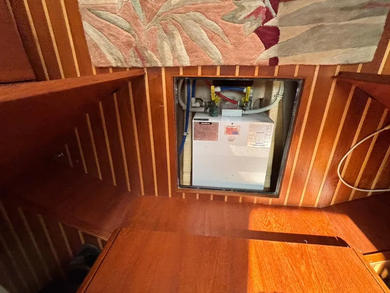 Slide: The Image of 2008 Tiara Yachts 3900 Sovran interior with wooden paneling and equipment access. - 39