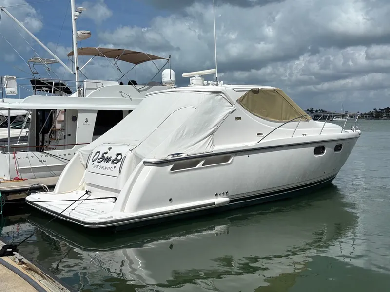 Slide: The Image of 2008 Tiara Yachts 3900 Sovran docked in a marina under cloudy skies. - 4