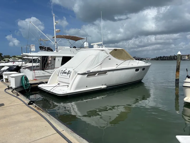 Slide: The Image of 2008 Tiara Yachts 3900 Sovran docked in a marina under cloudy skies. - 5