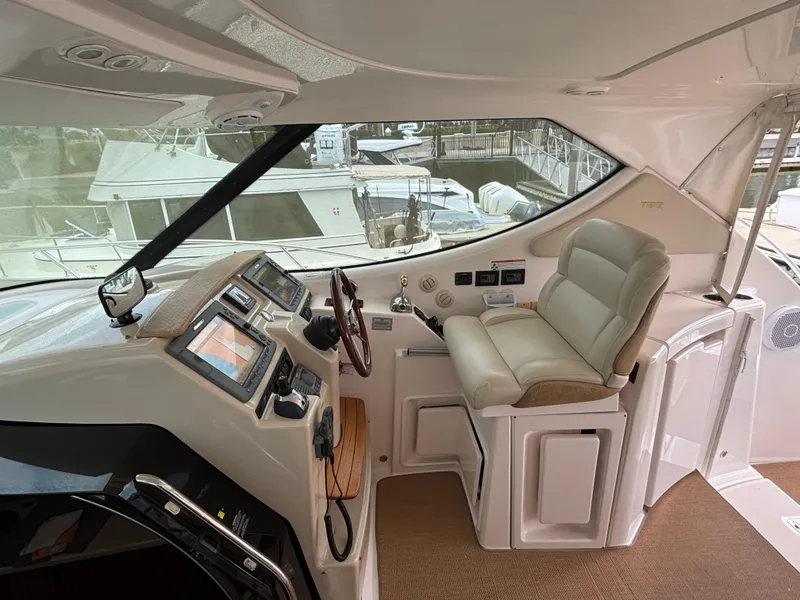 Slide: The Image of 2008 Tiara Yachts 3900 Sovran helm with modern controls and comfortable seating. - 7