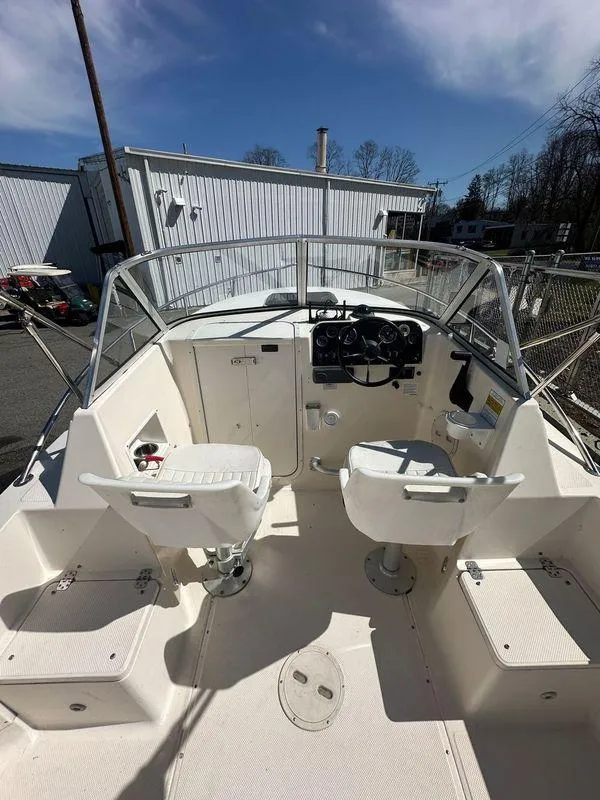 Slide: The Image of 1998 Key West 2020 Walkaround boat interior with dual seats and control panel. - 10