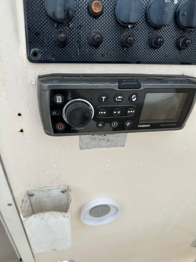 Slide: The Image of Control panel on a 1998 Key West 2020 Walkaround boat, featuring a Fusion audio system. - 12