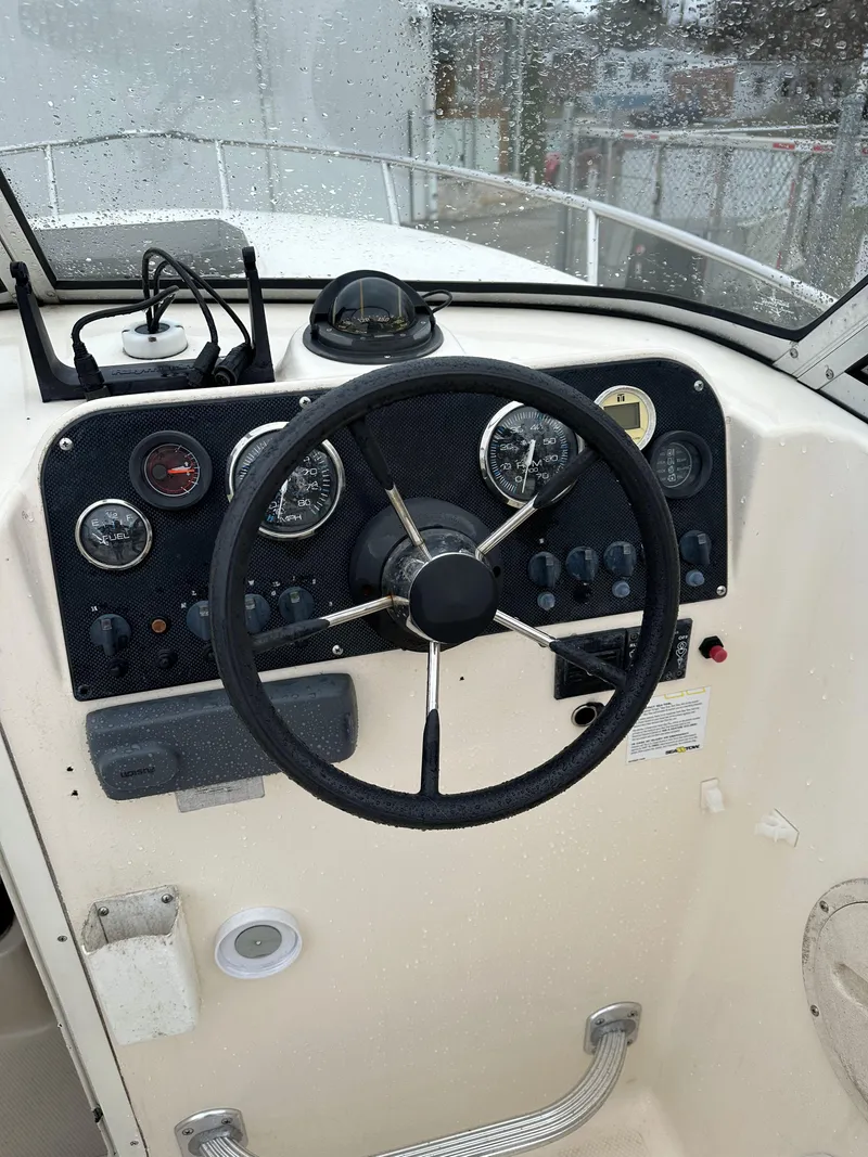Slide: The Image of Steering console of a 1998 Key West 2020 Walkaround boat, featuring gauges and controls. - 13