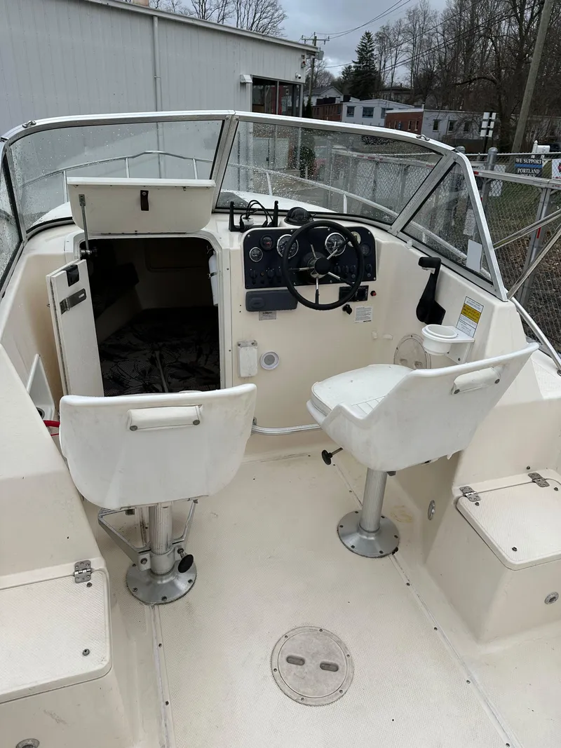 Slide: The Image of 1998 Key West 2020 Walkaround boat interior with steering wheel and seating. - 14