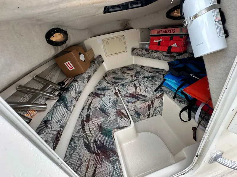 Slide: The Image of Interior of 1998 Key West 2020 Walkaround boat with life jackets and storage. - 15