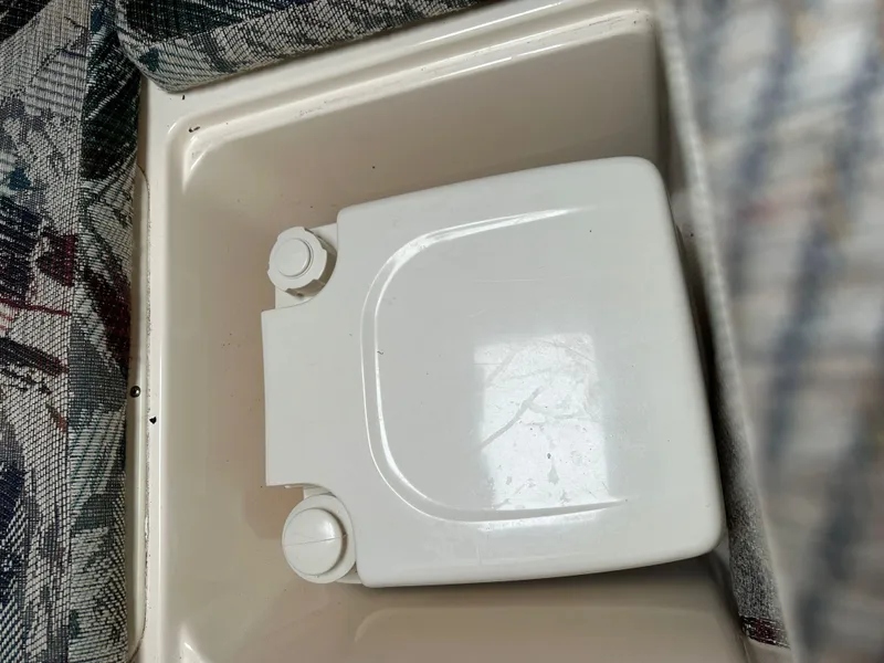 Slide: The Image of White portable toilet in a 1998 Key West 2020 Walkaround boat interior. - 17