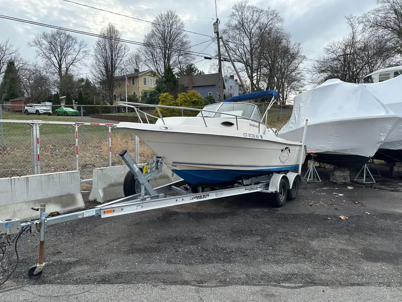 Slide: The Image of 1998 Key West 2020 Walkaround boat on trailer, parked outdoors. - 3