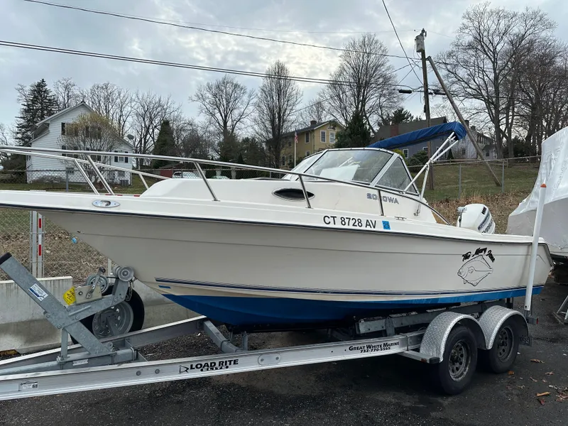Slide: The Image of 1998 Key West 2020 Walkaround boat on trailer, parked outdoors, overcast sky. - 4