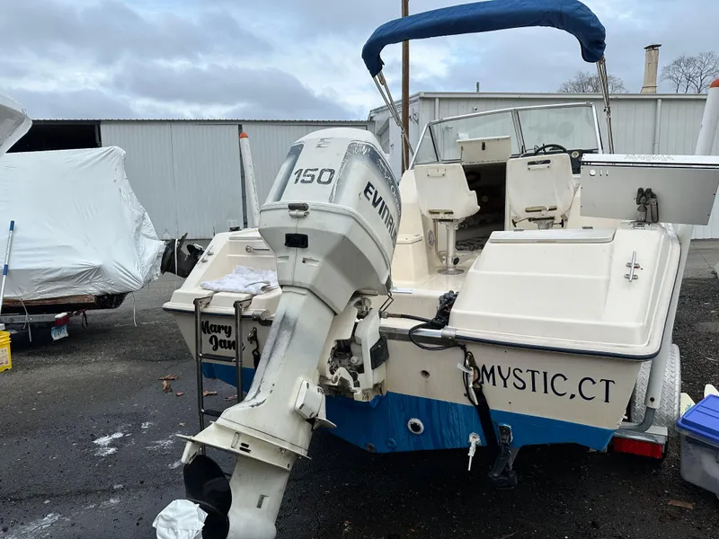 Slide: The Image of Key West 2020 Walkaround boat, 1998 model, with Evinrude 150 outboard motor, docked outdoors. - 7