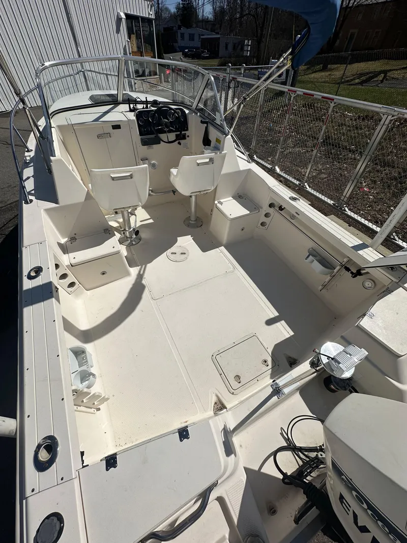 Slide: The Image of 1998 Key West 2020 Walkaround boat interior, featuring spacious seating and steering console. - 9