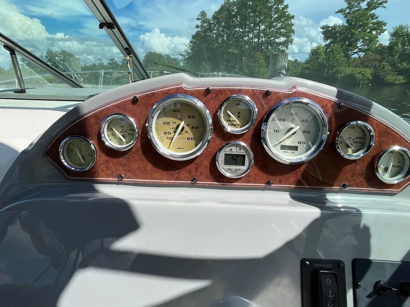 Slide: The Image of Dashboard of a 2006 Bayliner 265 Cruiser with multiple gauges and wood paneling. - 20