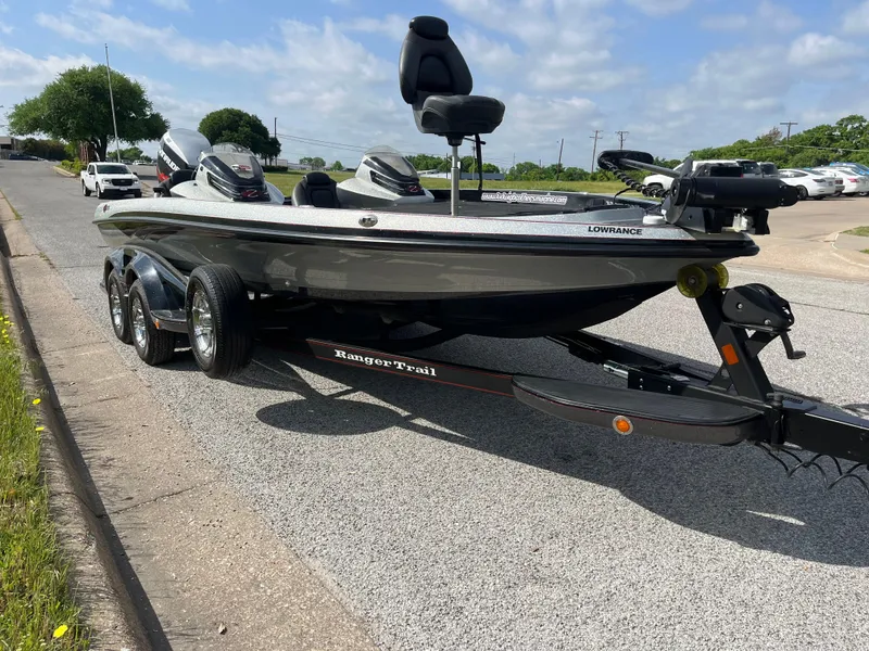 Slide: The Image of 2013 Ranger Z520C boat with Evinrude motor, parked on a sunny day. - 13