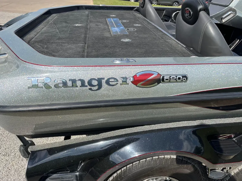 Slide: The Image of 2013 Ranger Z520C boat deck with storage compartments and seating area. - 16