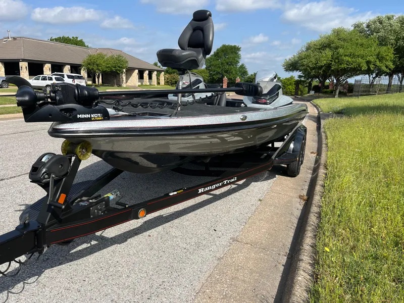 Slide: The Image of 2013 Ranger Z520C boat deck with chair, set in a grassy landscape. - 22
