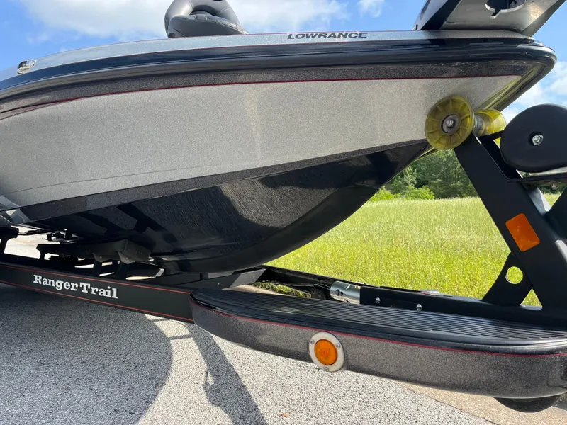 Slide: The Image of 2013 Ranger Z520C bass boat on trailer, parked on road near grassy field. - 24