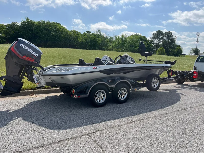 Slide: The Image of 2013 Ranger Z520C bass boat on trailer, parked on road with grassy background. - 27