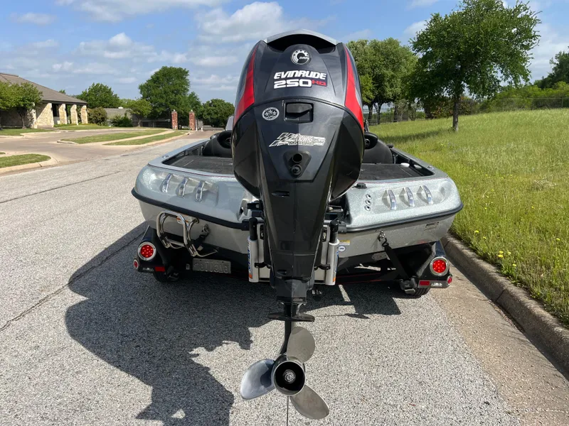 Slide: The Image of 2013 Ranger Z520C boat on trailer, parked on road with grassy background. - 3