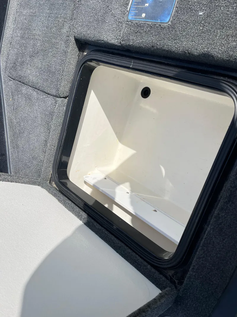 Slide: The Image of Storage compartment of a 2013 Ranger Z520C boat, featuring a clean, spacious interior. - 33