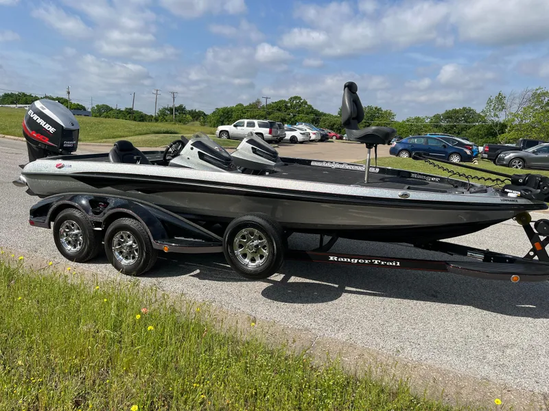 Slide: The Image of 2013 Ranger Z520C bass boat on trailer, parked outdoors under a partly cloudy sky. - 42