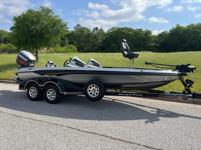 Slide: The Image of 2013 Ranger Z520C bass boat on trailer, parked on road with grassy background. - 43