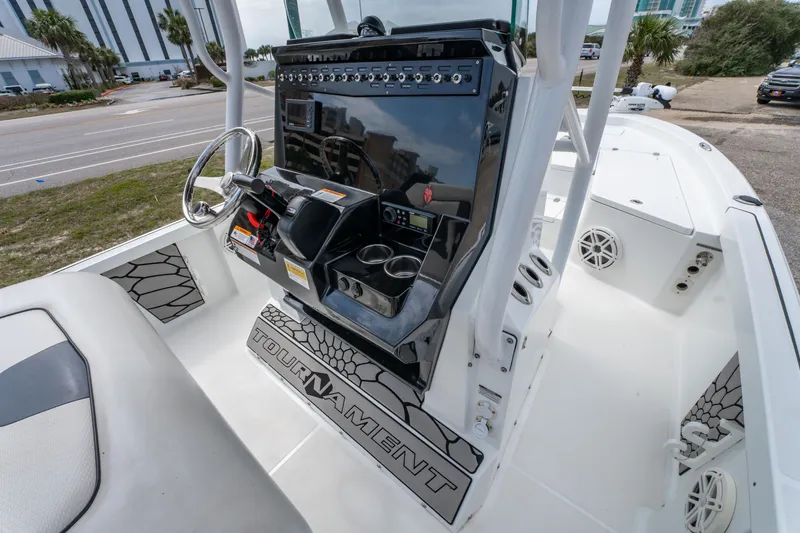 Slide: The Image of 2021 Wellcraft 221 Bay boat console with steering wheel and controls, featuring "Tournament" branding. - 10