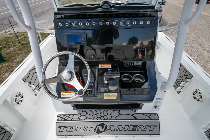 Slide: The Image of 2021 Wellcraft 221 Bay boat dashboard with steering wheel and controls. - 11