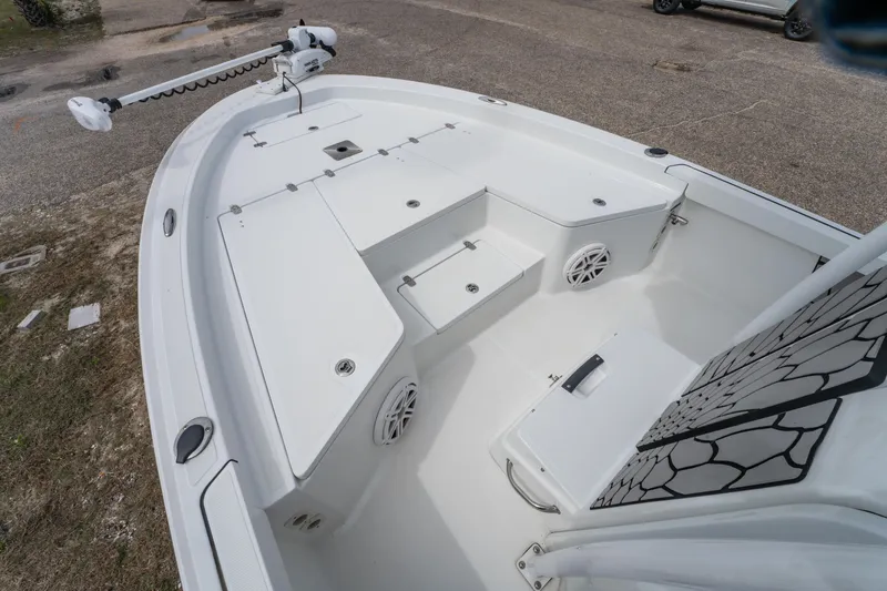 Slide: The Image of 2021 Wellcraft 221 Bay boat deck with storage compartments and trolling motor. - 14