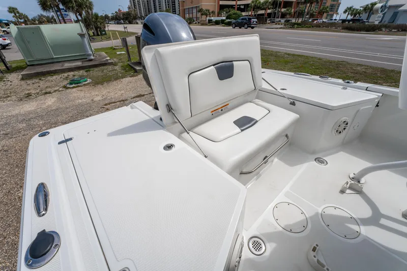 Slide: The Image of 2021 Wellcraft 221 Bay boat interior with white seating and storage compartments. - 16
