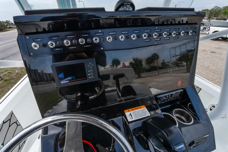 Slide: The Image of 2021 Wellcraft 221 Bay boat dashboard with controls and steering wheel. - 19