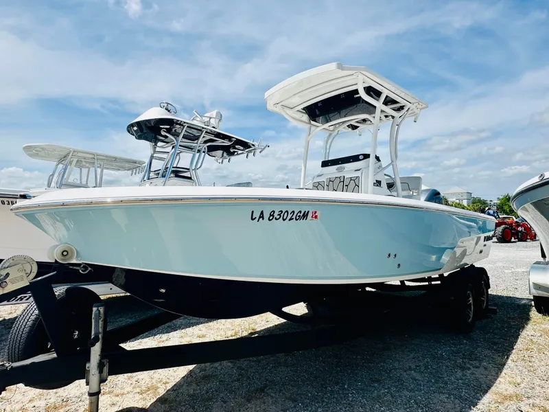Slide: The Image of 2021 Wellcraft 221 Bay boat on trailer under clear sky. - 2