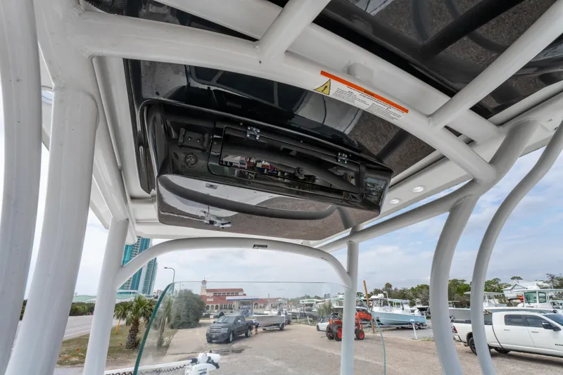 Slide: The Image of 2021 Wellcraft 221 Bay boat interior view with electronics and overhead structure. - 21