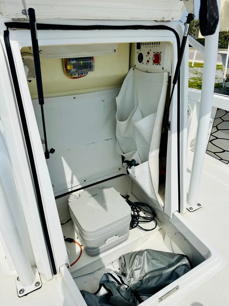 Slide: The Image of 2021 Wellcraft 221 Bay boat storage compartment with equipment and wiring. - 26