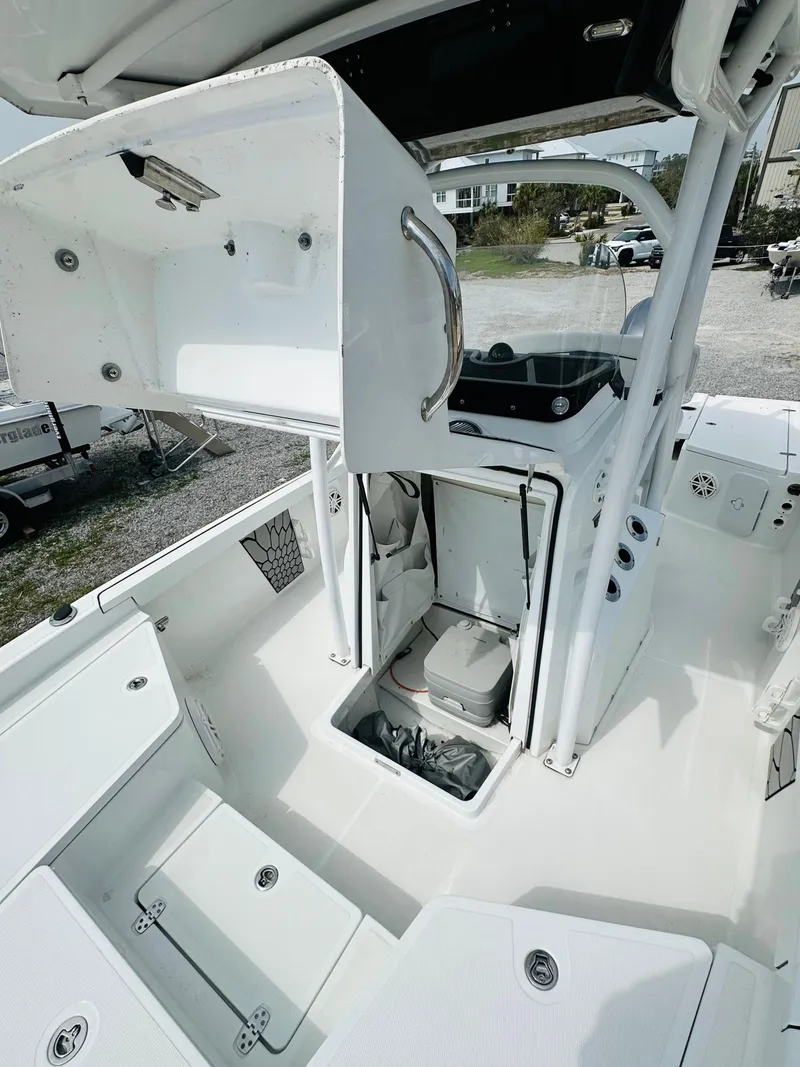 Slide: The Image of 2021 Wellcraft 221 Bay boat interior with storage compartments and seating. - 27