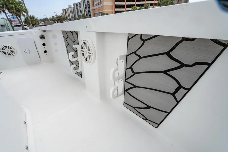 Slide: The Image of 2021 Wellcraft 221 Bay boat interior with speakers and storage compartments. - 31