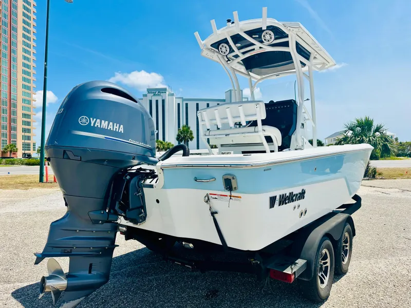 Slide: The Image of 2021 Wellcraft 221 Bay boat with Yamaha engine on trailer, parked outdoors. - 5