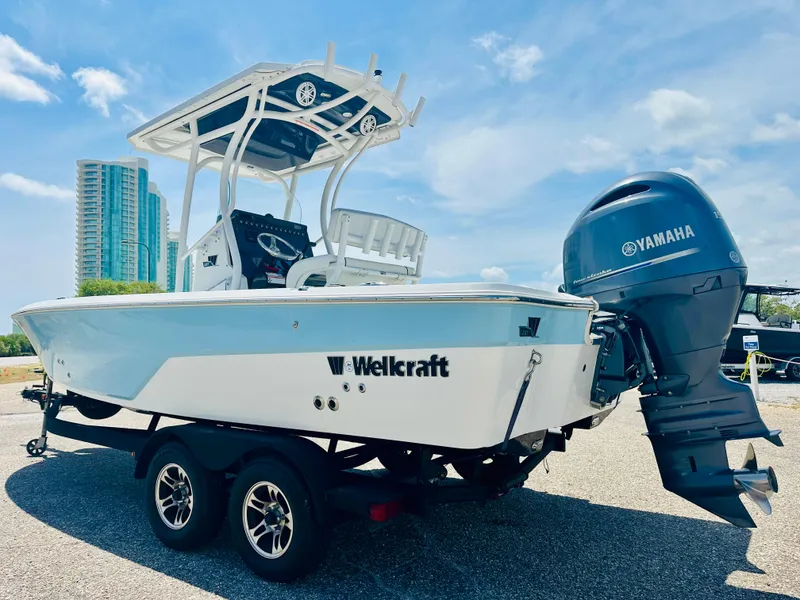 Slide: The Image of 2021 Wellcraft 221 Bay boat with Yamaha engine on trailer, parked outdoors. - 6