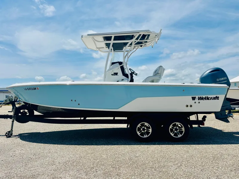 Slide: The Image of 2021 Wellcraft 221 Bay boat on trailer, featuring sleek design and Yamaha outboard motor. - 8