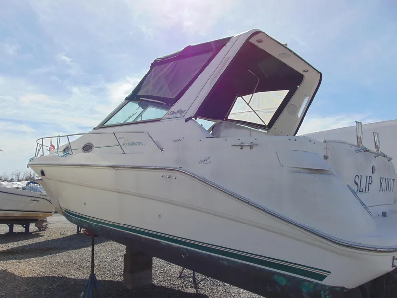 Slide: The Image of 1995 Sea Ray 290DA boat on dry dock under a clear sky. - 3