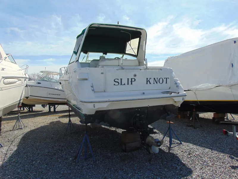 Slide: The Image of 1995 Sea Ray 290DA boat named "Slip Knot" on stands in a boatyard. - 4